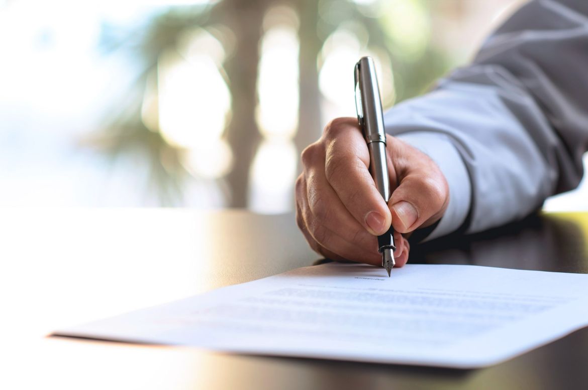 Businessman Signing An Official Document