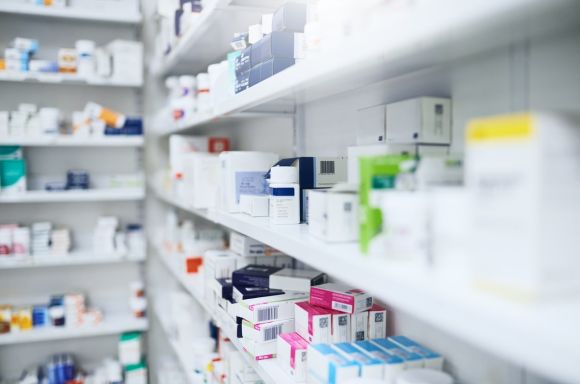 Pharmacy shelves stocked with medicinal products