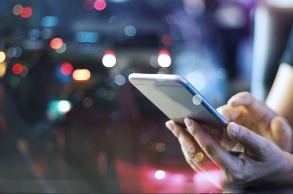 Woman using mobile smart phone in the night light