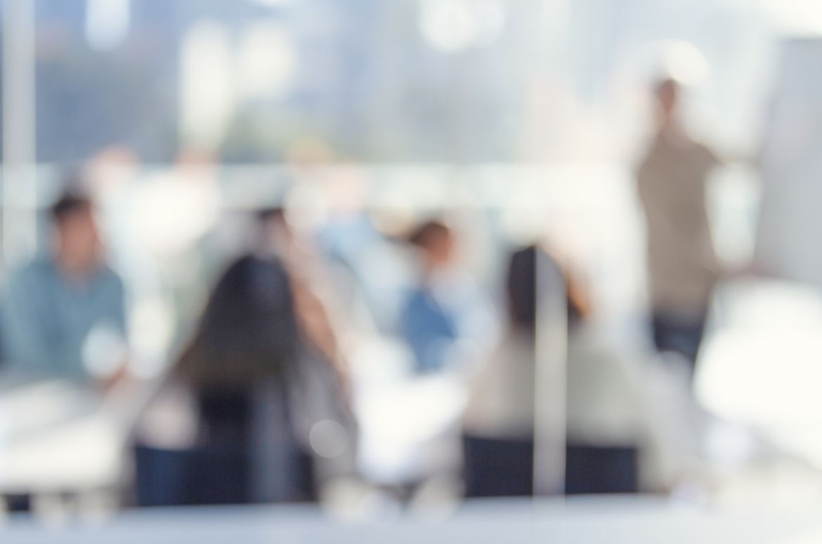 Defocussed image of Business people watching a presentation