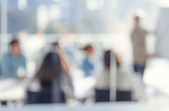 Defocussed image of Business people watching a presentation