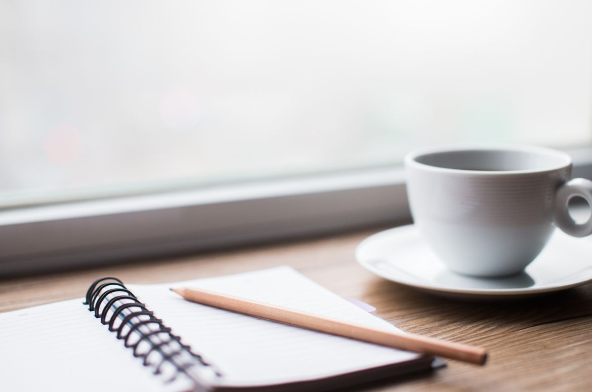 Working desk with notebook and coffee