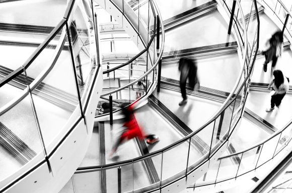 Business people walking spiral staircase
