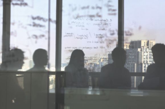 Meeting blurred with text on wall