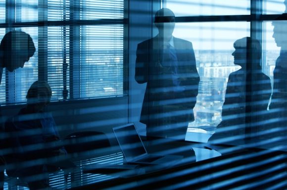People in meeting room behind blinds v2
