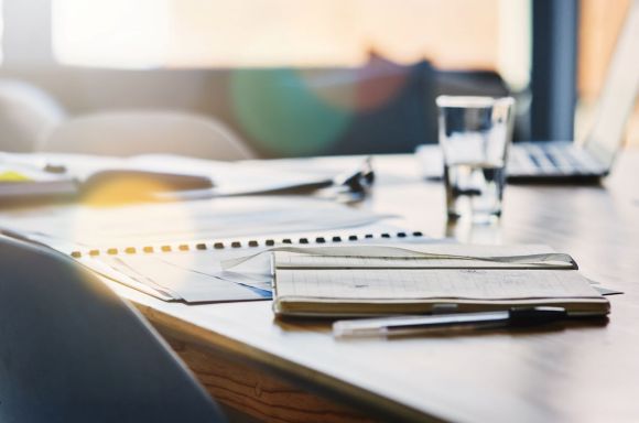 Still life shot of paperwork on a table in an office