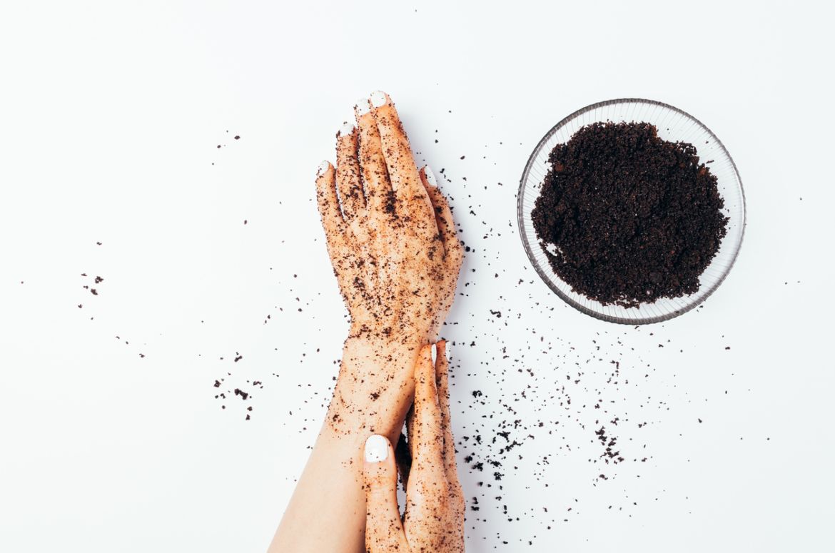 Woman using coffee scrub