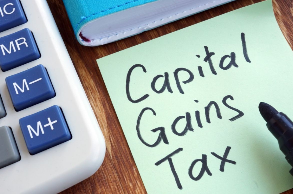 capital gains tax memo stick and calculator picture id1097299068