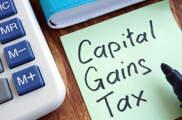 capital gains tax memo stick and calculator picture id1097299068
