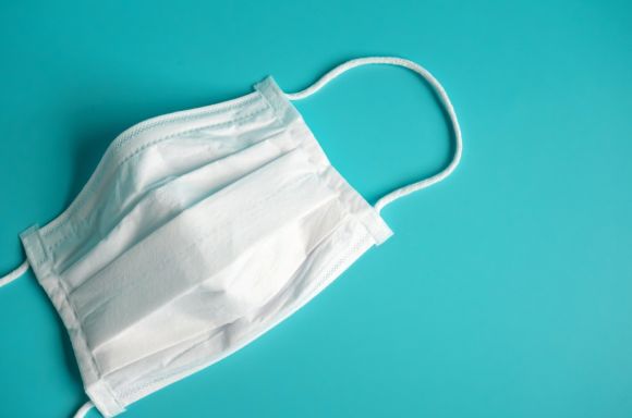 close up white surgical face mask on blue green background the mask picture id1209610671