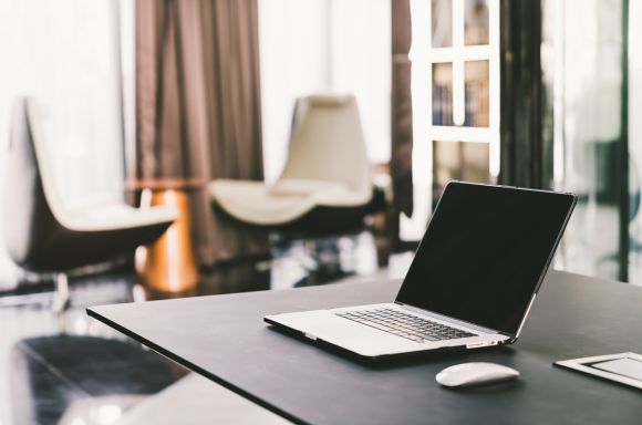 Laptop computer on work table in modern luxury contemporary office
