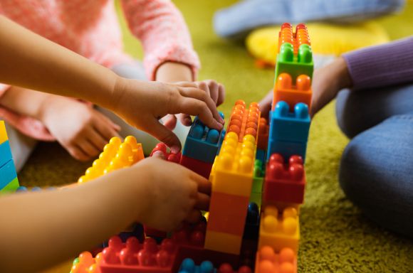 Kids hands playing with toy blocks
