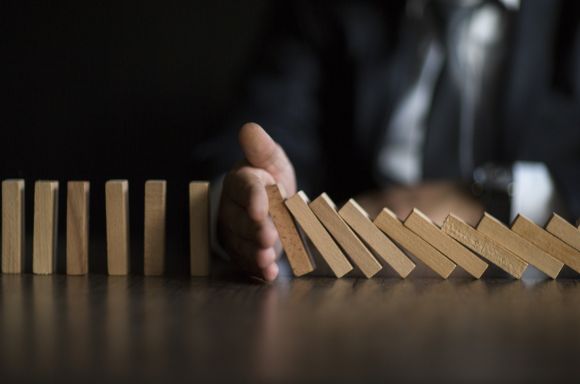 Businessman Stop Domino Effect
