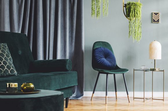 Modern living room interior with green velvet sofa and chair