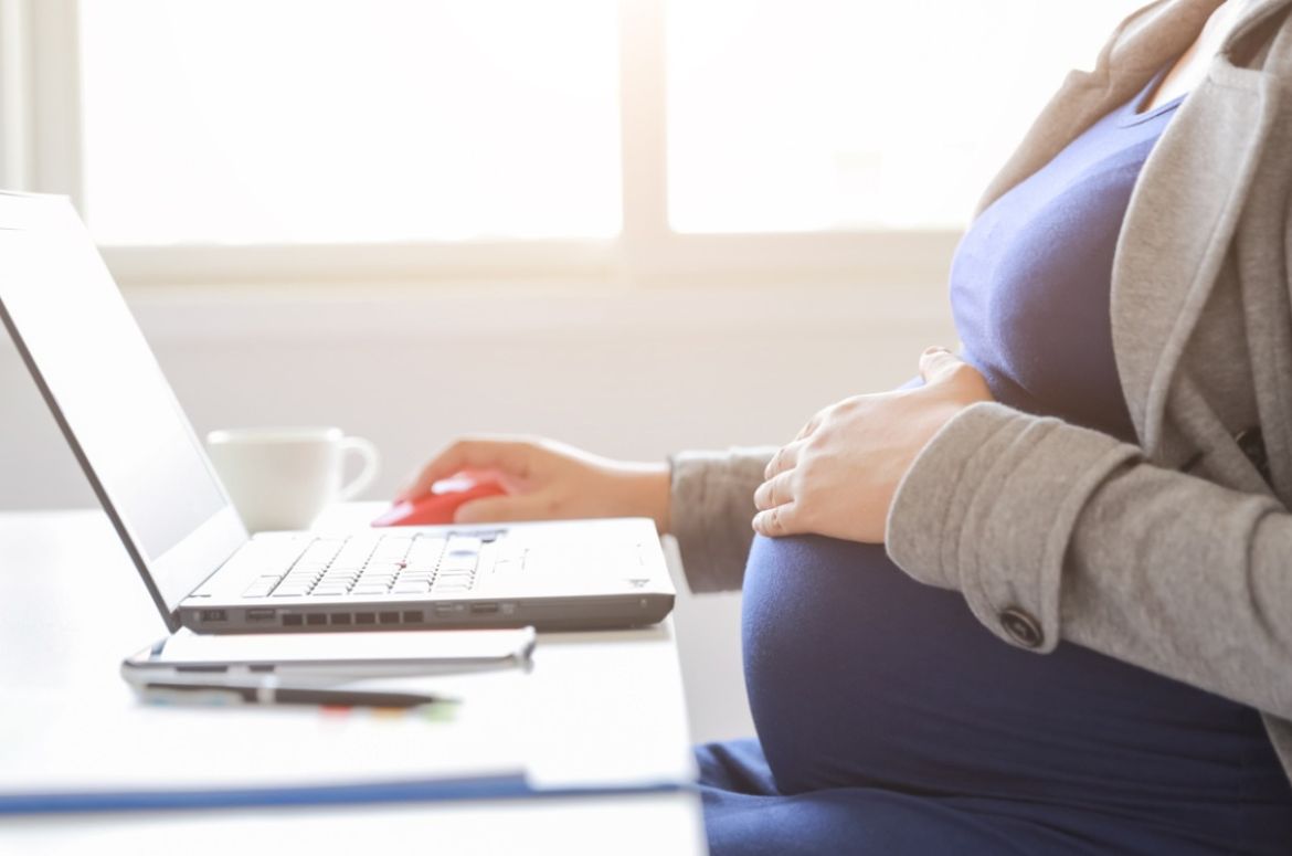 pregnant woman is working on computer laptop and mobile phone picture id1163527047
