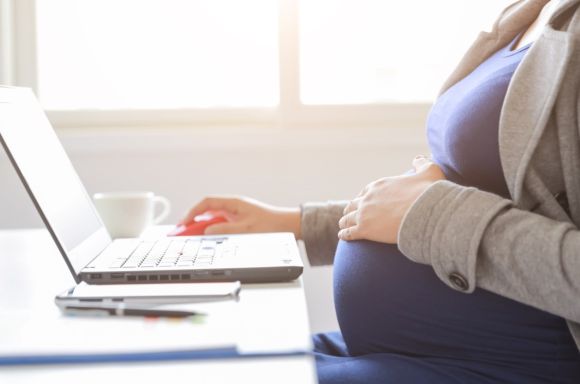 pregnant woman is working on computer laptop and mobile phone picture id1163527047